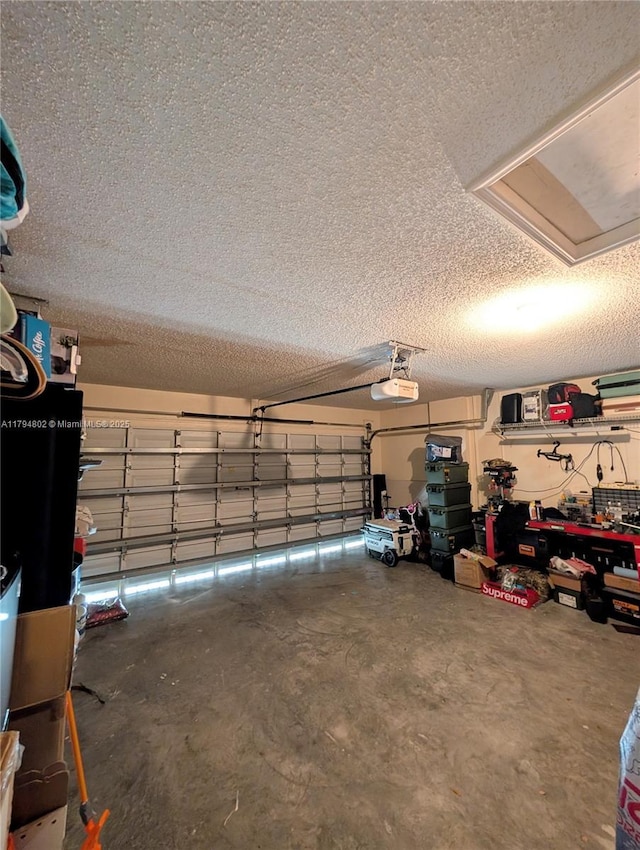 garage featuring a garage door opener and a workshop area