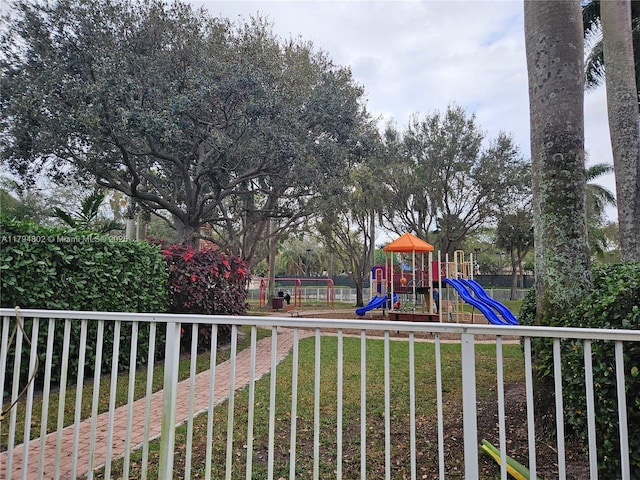 view of play area featuring a lawn and fence