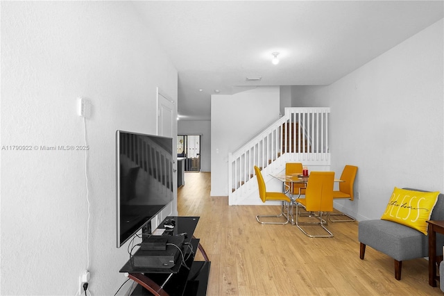 interior space featuring baseboards, wood finished floors, and stairway