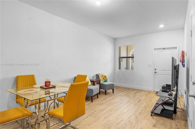 dining room featuring recessed lighting, baseboards, and light wood-type flooring