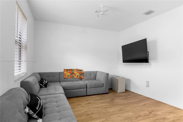 living room featuring wood finished floors and visible vents
