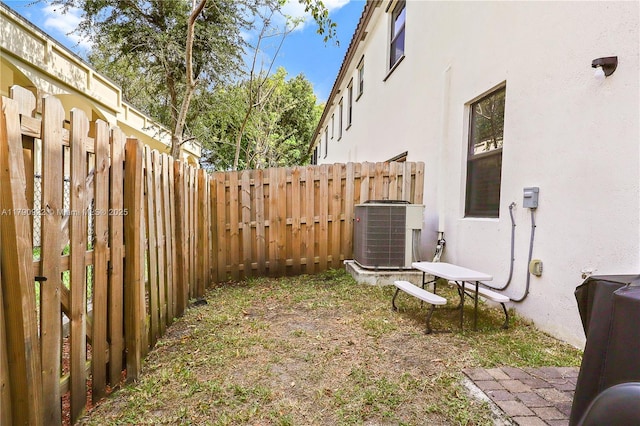 view of yard featuring central air condition unit and a fenced backyard