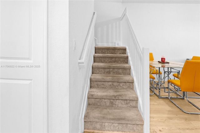 staircase with wood finished floors