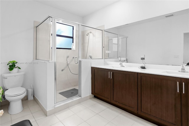 bathroom with double vanity, a sink, toilet, and a shower stall