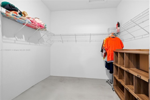 walk in closet featuring attic access