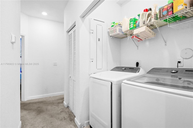 clothes washing area with separate washer and dryer, laundry area, baseboards, and light carpet
