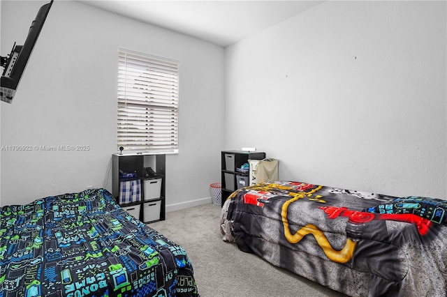 carpeted bedroom featuring baseboards