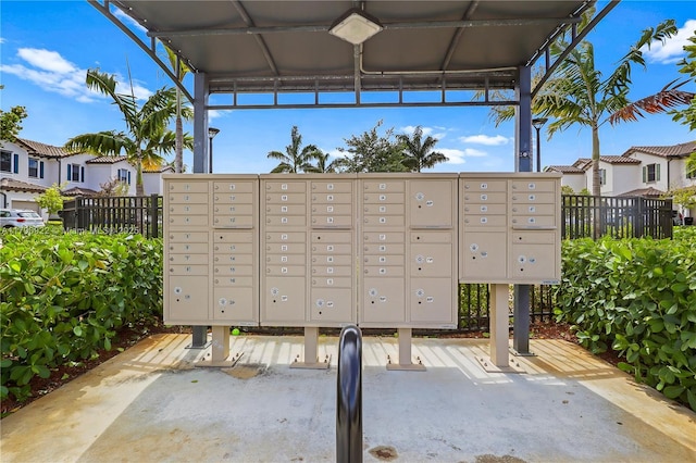view of property's community with fence and mail area