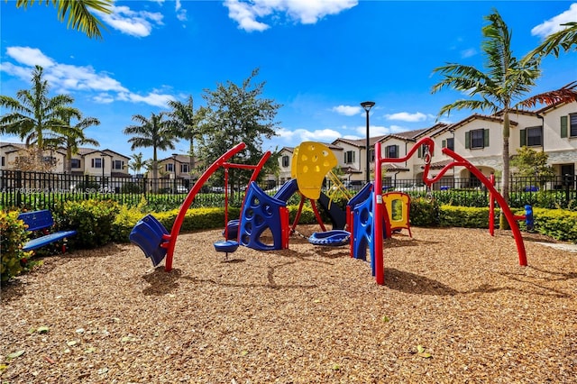 community playground featuring a residential view and fence