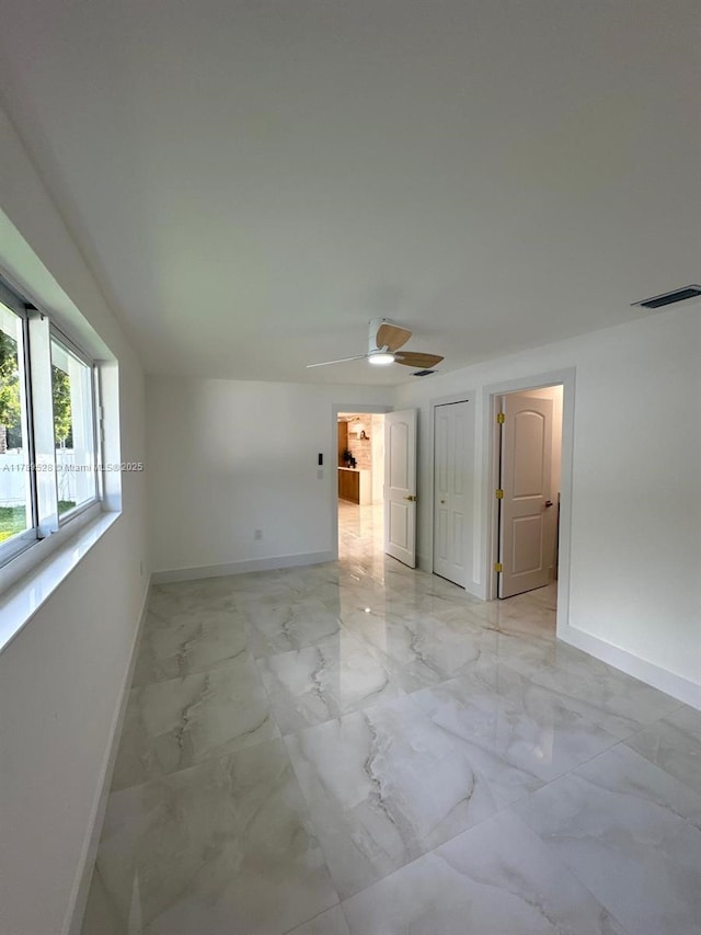 360 NE 118th St, Miami, FL 33161 - unfurnished room with baseboards, a ceiling fan, marble finish floor, and visible vents