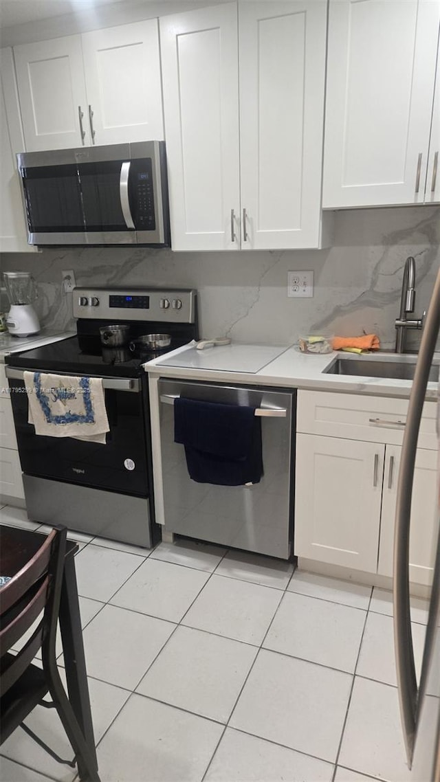 3841 Environ Blvd Unit 430, Lauderhill, FL 33319 - kitchen featuring white cabinets, appliances with stainless steel finishes, a sink, and light countertops