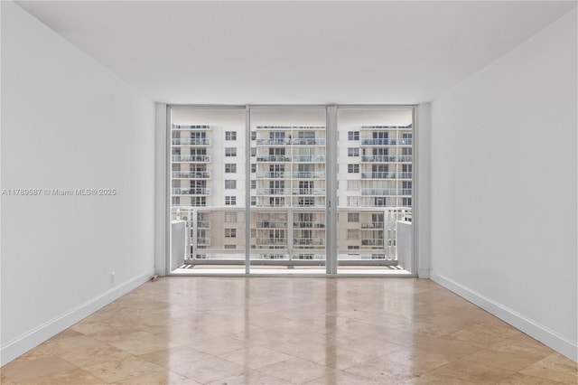 5700 Collins Ave Unit 10D, Miami Beach, FL 33140 - unfurnished room featuring expansive windows and baseboards