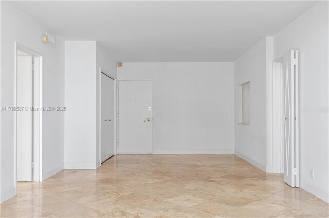 5700 Collins Ave Unit 10D, Miami Beach, FL 33140 - unfurnished bedroom featuring a closet and baseboards