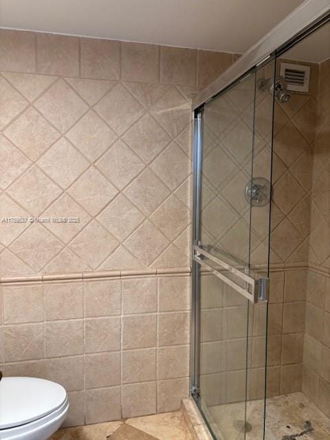 full bathroom featuring toilet, visible vents, and a stall shower