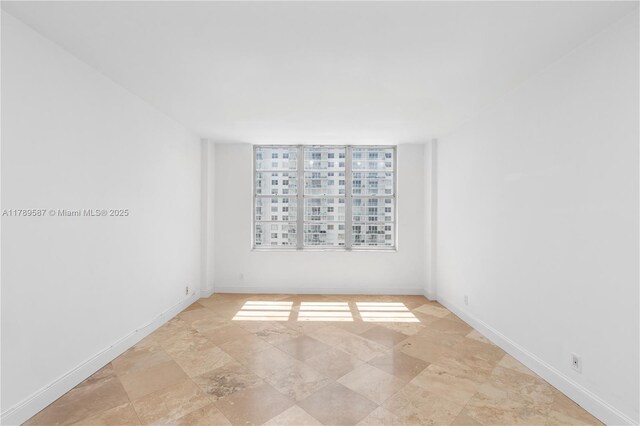 5700 Collins Ave Unit 10D, Miami Beach, FL 33140 - kitchen with stainless steel appliances, white cabinets, and light countertops