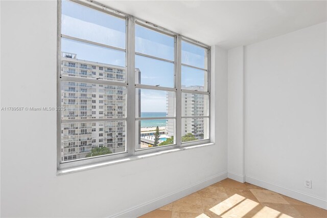 5700 Collins Ave Unit 10D, Miami Beach, FL 33140 - kitchen with appliances with stainless steel finishes, white cabinets, and light countertops