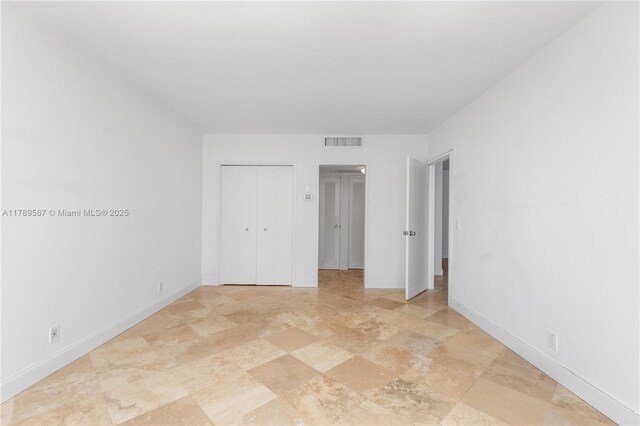 5700 Collins Ave Unit 10D, Miami Beach, FL 33140 - kitchen with stainless steel appliances and white cabinetry