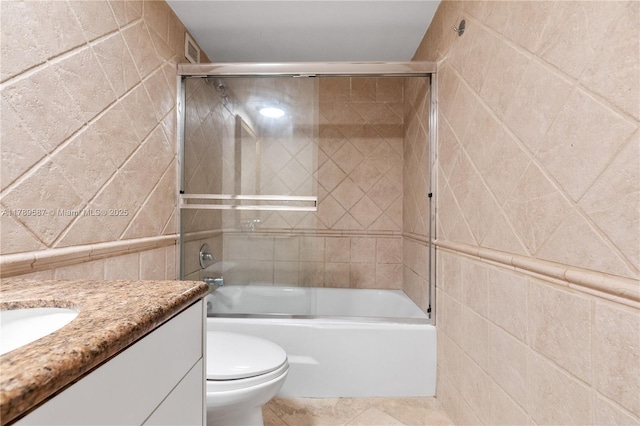 5700 Collins Ave Unit 10D, Miami Beach, FL 33140 - full bathroom featuring tile walls, vanity, and bath / shower combo with glass door