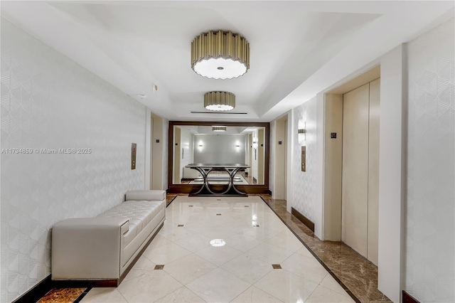 hall with elevator and wallpapered walls