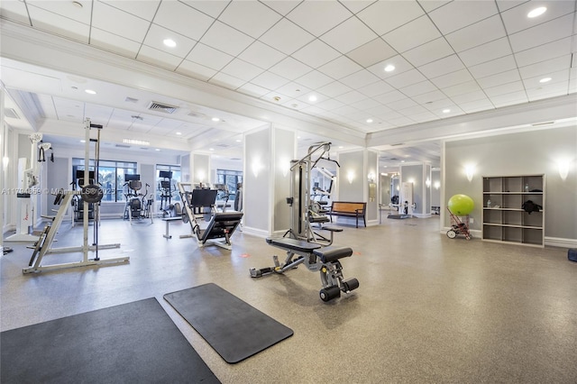 gym featuring baseboards, ornamental molding, and visible vents
