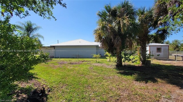 3054 NE Beechwood Cir, La Belle, FL 33935 - view of yard featuring a fenced backyard