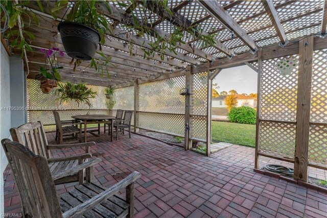 3054 NE Beechwood Cir, La Belle, FL 33935 - view of patio / terrace featuring outdoor dining area and a pergola