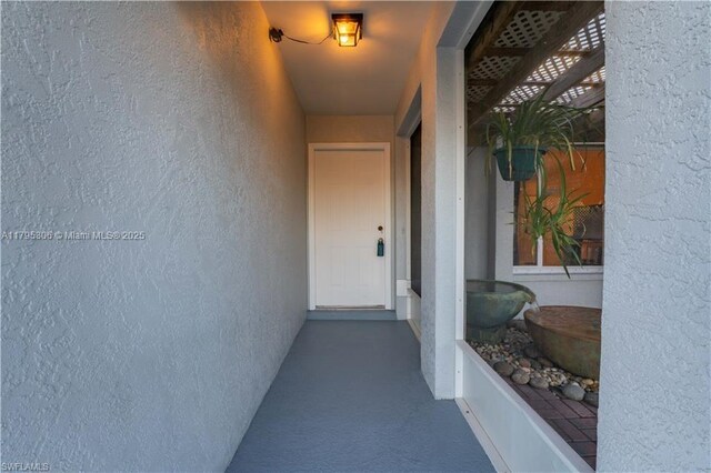 3054 NE Beechwood Cir, La Belle, FL 33935 - view of exterior entry with stucco siding