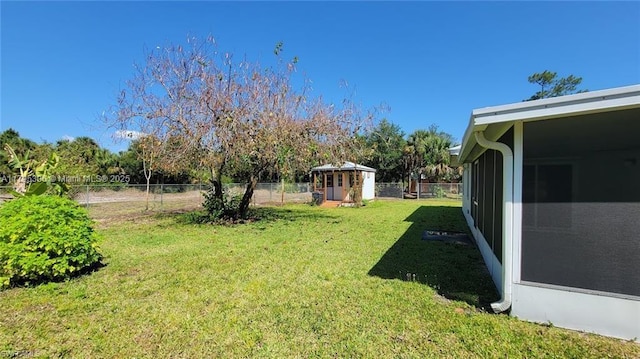 view of yard with an outdoor structure, a shed, and a fenced backyard