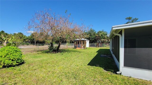 3054 NE Beechwood Cir, La Belle, FL 33935 - view of yard with an outdoor structure, a shed, and a fenced backyard