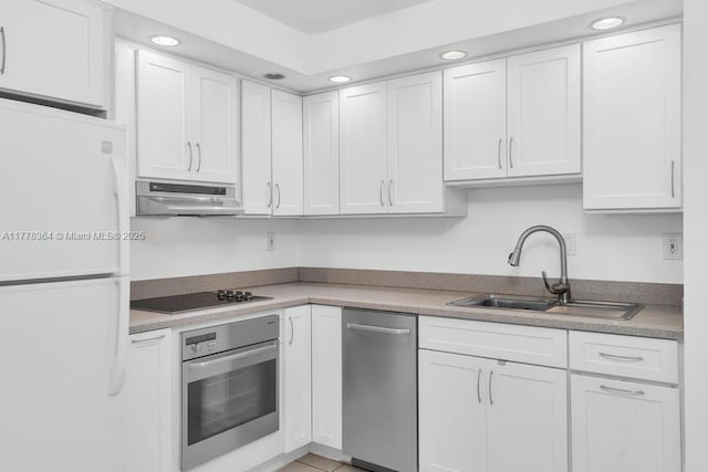kitchen with a sink, white cabinets, stainless steel appliances, and under cabinet range hood