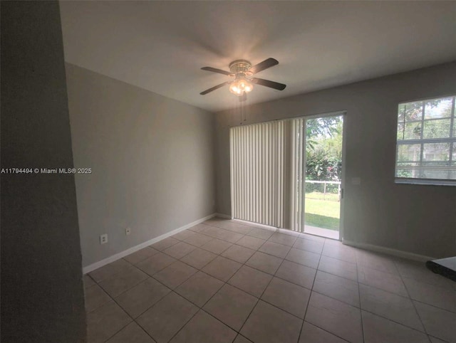 spare room featuring tile patterned floors, baseboards, and a ceiling fan