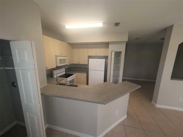 kitchen featuring white appliances, a peninsula, baseboards, light tile patterned floors, and visible vents