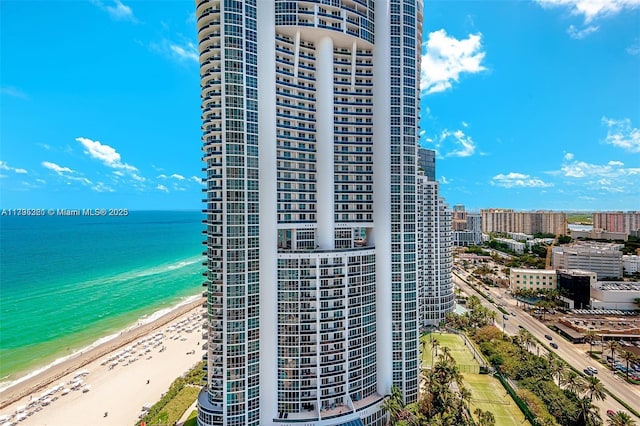 view of property featuring a view of city, a view of the beach, and a water view