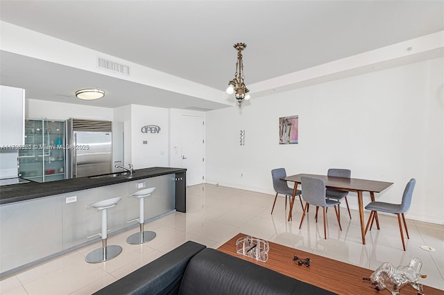 dining room featuring visible vents, baseboards, and light tile patterned floors