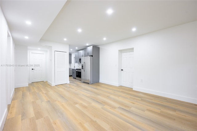 736 NE 164th St, Miami, FL 33162 - unfurnished living room featuring light wood-style flooring, baseboards, and recessed lighting
