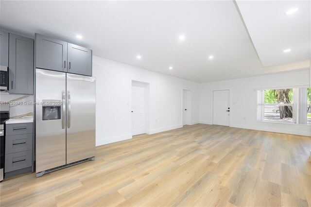 736 NE 164th St, Miami, FL 33162 - kitchen featuring appliances with stainless steel finishes, light wood-style floors, gray cabinetry, light countertops, and baseboards