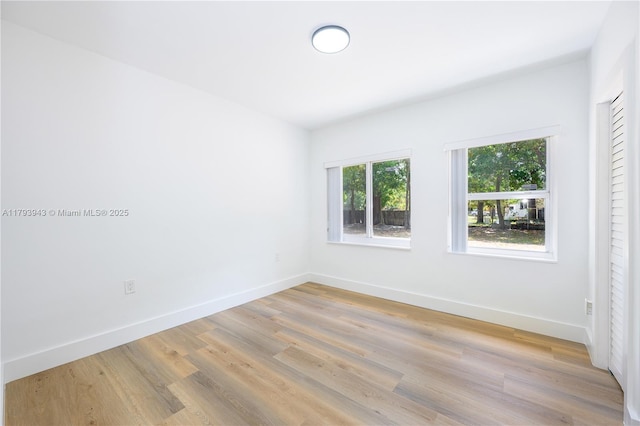 736 NE 164th St, Miami, FL 33162 - empty room with light wood finished floors and baseboards