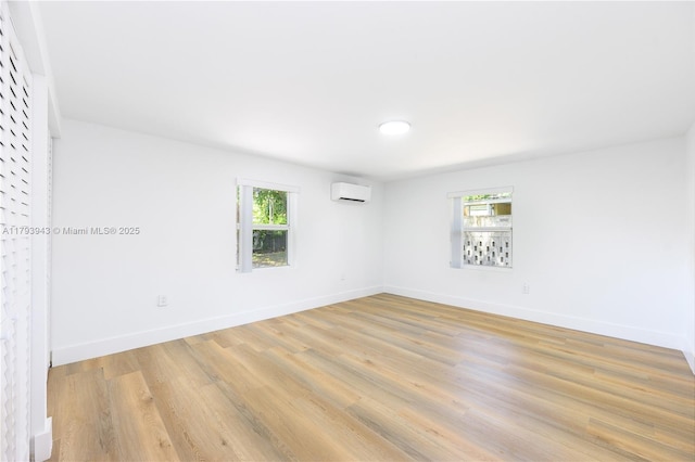 736 NE 164th St, Miami, FL 33162 - empty room featuring a wall mounted AC, light wood-type flooring, baseboards, and recessed lighting