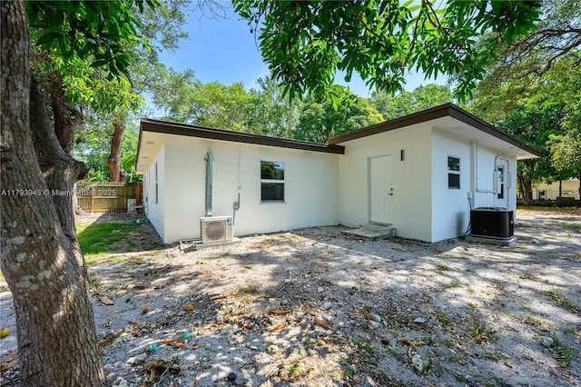 736 NE 164th St, Miami, FL 33162 - back of property featuring stucco siding, central AC, and ac unit