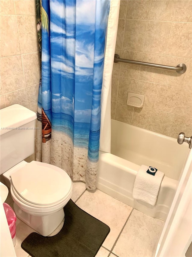 bathroom with toilet, tile patterned flooring, and shower / bath combo with shower curtain