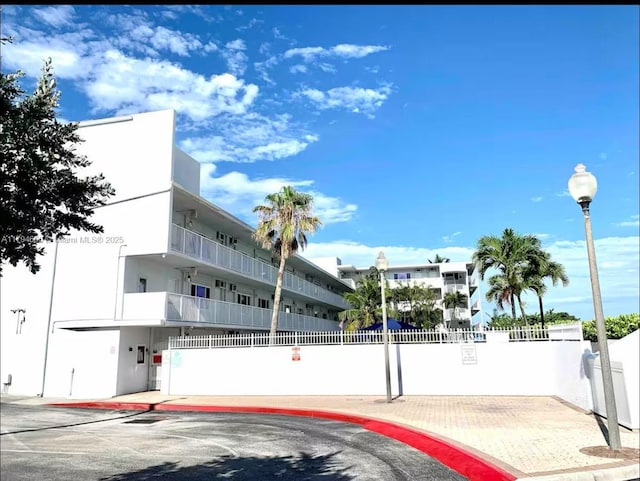 view of building exterior featuring fence