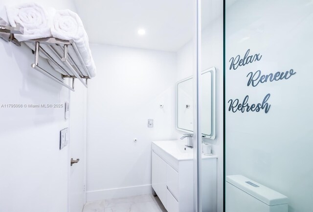 14354 SW 113th Ter, Miami, FL 33186 - bathroom featuring toilet, baseboards, marble finish floor, and vanity