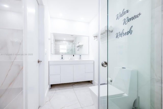 bathroom featuring vanity, a stall shower, and marble finish floor