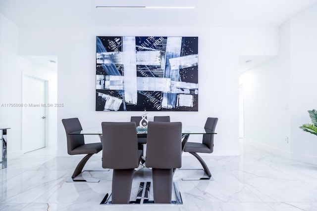 dining room featuring baseboards and marble finish floor