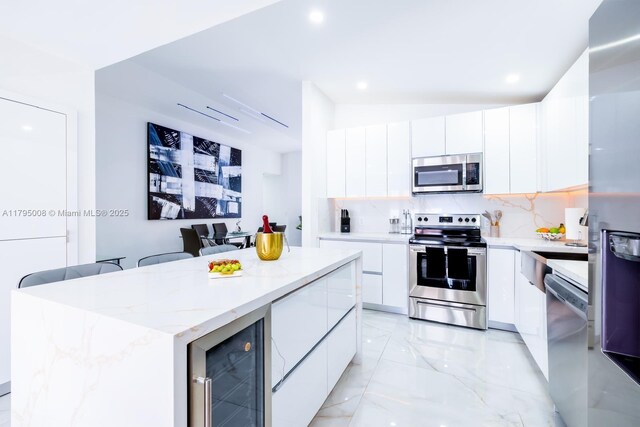 14354 SW 113th Ter, Miami, FL 33186 - kitchen with beverage cooler, appliances with stainless steel finishes, white cabinetry, and modern cabinets