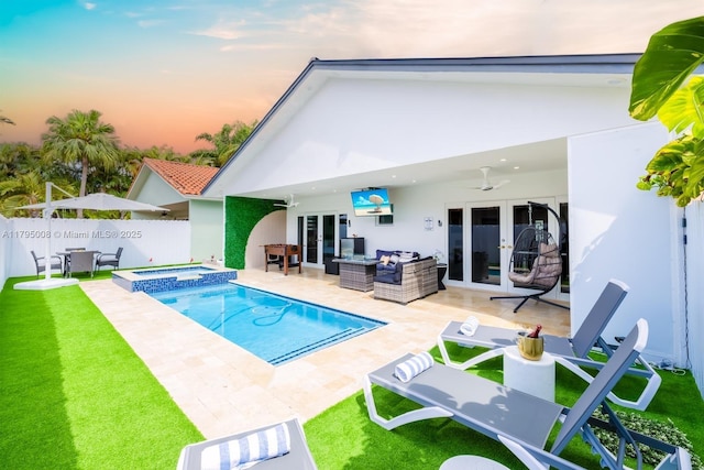 rear view of property with a ceiling fan, french doors, fence, a patio, and outdoor lounge area
