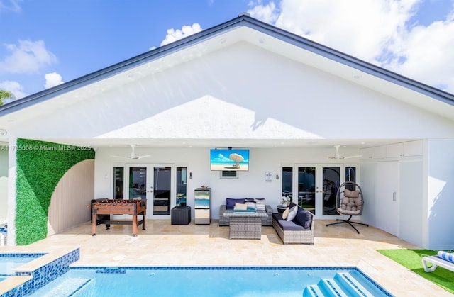 rear view of property with french doors, a pool with connected hot tub, a patio area, an outdoor hangout area, and stucco siding