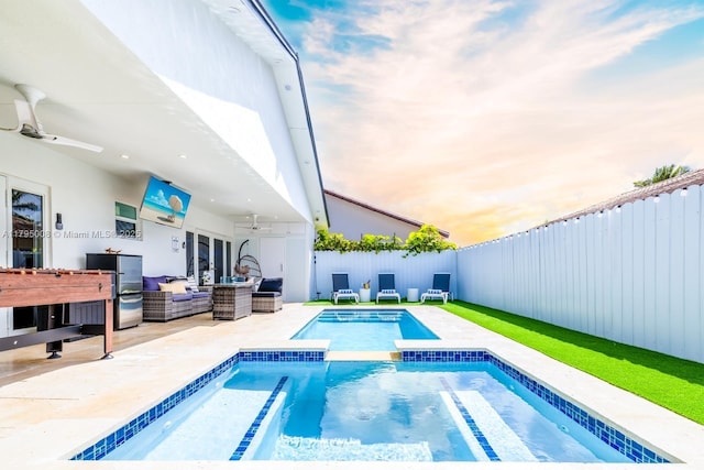view of pool with a patio, a fenced backyard, an outdoor living space, a ceiling fan, and a pool with connected hot tub