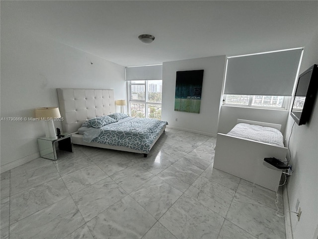 bedroom featuring baseboards and marble finish floor
