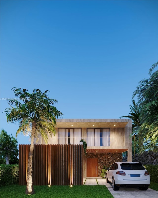view of front of home with fence, a carport, and driveway